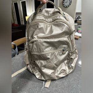 Kipling gold backpack.